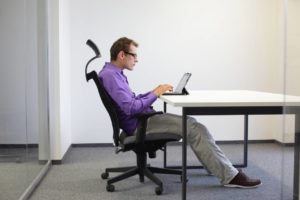 man slouching at desk