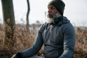 man meditating outside